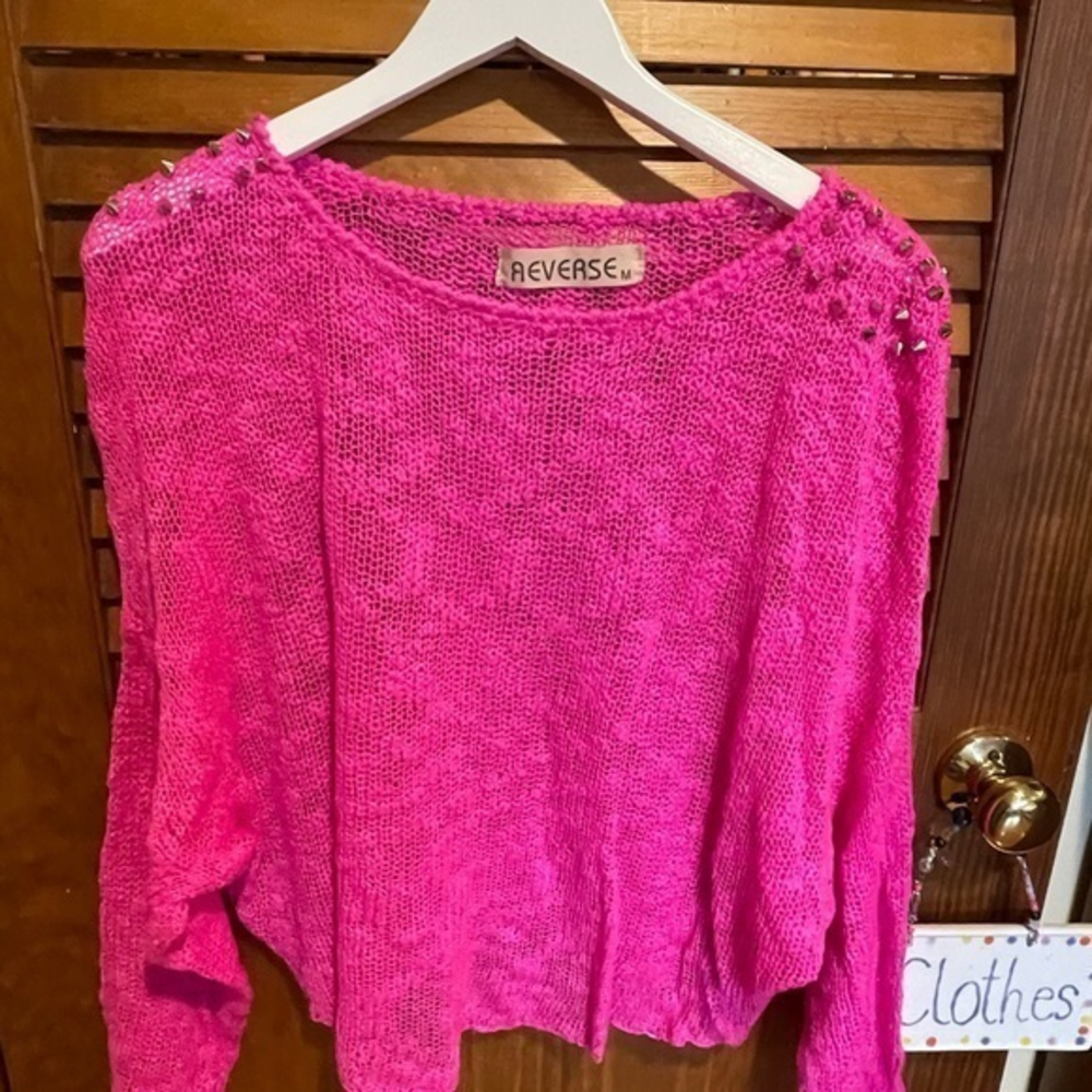 Hot pink light knit sweater with stud detail on shoulders